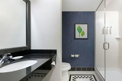 a bathroom with a sink and a toilet and a shower at Fairfield Inn and Suites Turlock in Turlock