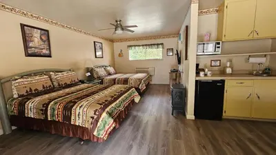 a hotel room with two beds and a kitchen at Sequoia Lodge in Kernville