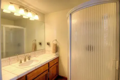 a bathroom with a shower and a sink at Alder Lodge in Yosemite West