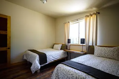 a small room with two beds and a window at Alpenglow 2 in Yosemite West