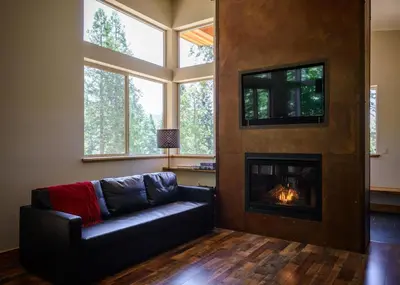 a living room with a couch and a fireplace at Alpenglow 2 in Yosemite West