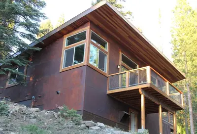 a house with a balcony on the side of it at Alpenglow 3 in Yosemite West