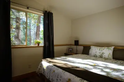 a bedroom with a bed and a large window at Alpenglow 3 in Yosemite West