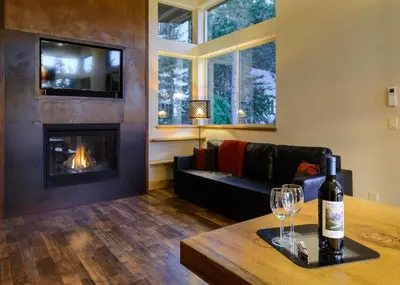 a living room with a bottle of wine on a table at Alpenglow 3 in Yosemite West
