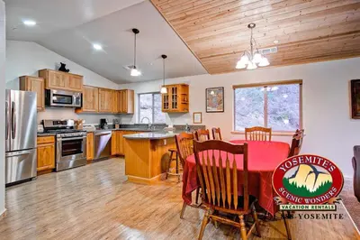 a large kitchen with a table and a dining room at Explorers Retreat in Yosemite West
