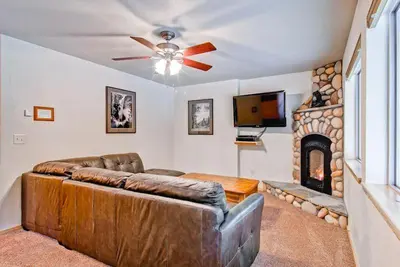 a living room with a couch and a fireplace at Explorers Retreat in Yosemite West