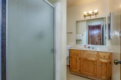a bathroom with a sink and a mirror at Hutchings Cabin & Apt. in Yosemite West