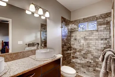 a bathroom with a sink and a toilet and a shower at Kildrummy Lodge in Yosemite West