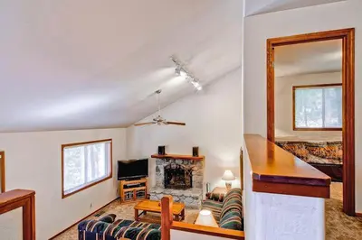 a living room with a couch and a fireplace at Little Sport in Yosemite West
