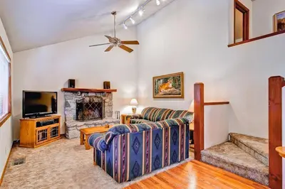 a living room with a couch and a fireplace at Little Sport in Yosemite West