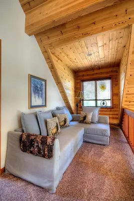 a living room with two couches and a wooden ceiling at Mystic Views in Yosemite West