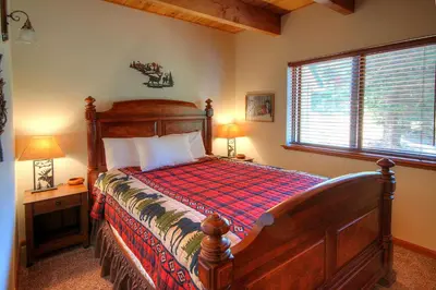 a bedroom with a bed and a large window at Mystic Views in Yosemite West