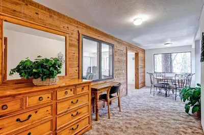 a living room with a wooden dresser and a dining room at Sport Chalet in Yosemite West