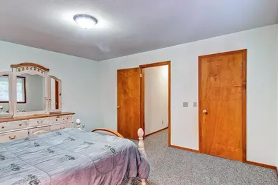 a bedroom with a bed and a dresser and a mirror at Sport Chalet in Yosemite West