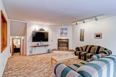 a living room with two couches and a television at Sport Chalet in Yosemite West