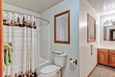 a bathroom with a toilet and a shower curtain at Sport Chalet in Yosemite West