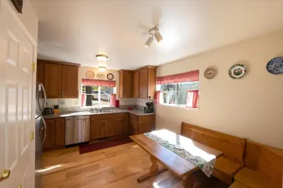 a kitchen with wooden cabinets and a wooden table at Yosemite Park Place in Yosemite West