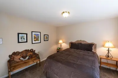 a bedroom with a large bed and two lamps at Yosemite Park Place in Yosemite West