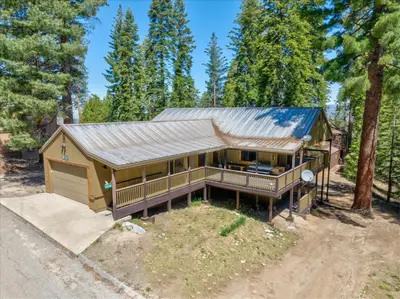 a large house with a metal roof at Quail Crossing Lodge in Yosemite West