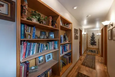 a hallway with wooden book shelves filled with books at Starlight Lodge in Yosemite West