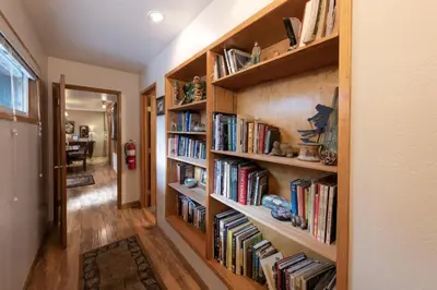 a hallway with wooden book shelves filled with books at Starlight Lodge in Yosemite West