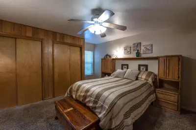 a bedroom with a bed and a ceiling fan at Starlight Lodge in Yosemite West