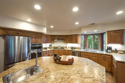 a kitchen with wooden cabinets and a wooden bowl on a counter at Four Seasons in Yosemite West