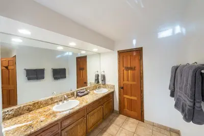 a bathroom with two sinks and a large mirror at Four Seasons in Yosemite West