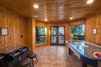 a pool table in a room with wooden walls at Four Seasons in Yosemite West