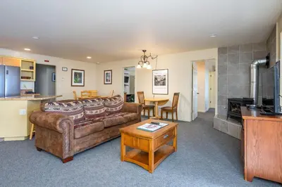 a living room with a couch and a table at Falcons Nest (Downstairs) in Yosemite West