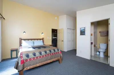 a bedroom with a bed and a toilet at Falcons Nest (Downstairs) in Yosemite West