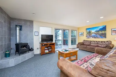 a living room with a couch and a fireplace at Falcons Nest (Downstairs) in Yosemite West
