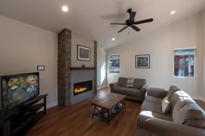 a living room with a couch and a fireplace at Boulder Ridge in Yosemite West