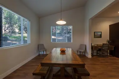 a dining room with a wooden table in a room with a window at Boulder Ridge in Yosemite West
