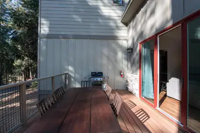 a porch with benches on the side of a house at Boulder Ridge in Yosemite West