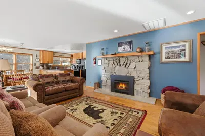 a living room with a couch and a fireplace at Apple Tree Bear House in Yosemite West