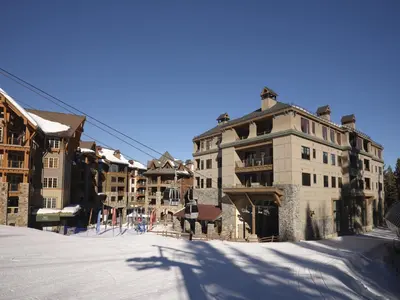 a group of buildings on a snow covered street at The Residences at One Village Place by Hyatt Vacation Club in Truckee