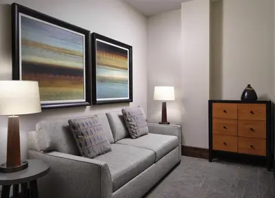 a living room with a couch and a dresser at The Residences at One Village Place by Hyatt Vacation Club in Truckee