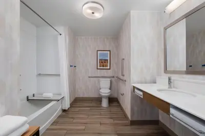 a bathroom with a sink and a toilet and a tub at Hampton Inn by Hilton Turlock in Turlock