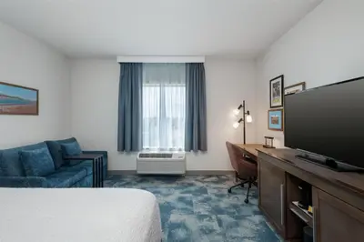 a hotel room with a bed and a flat screen tv at Hampton Inn by Hilton Turlock in Turlock