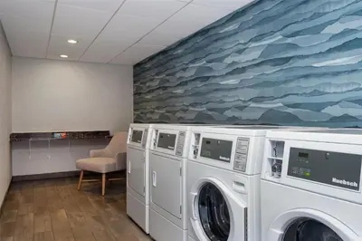 a room with two washing machines and a painting at Hampton Inn by Hilton Turlock in Turlock