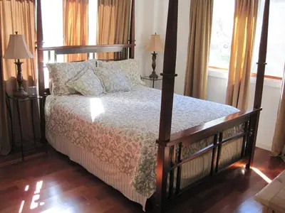 a bedroom with a bed and two lamps and windows at Alta Peak Vista in Three Rivers