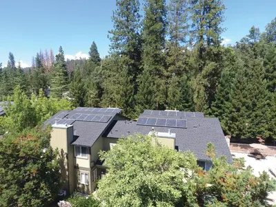 an aerial view of a house with solar panels on the roof at WorldMark Bass Lake in Bass Lake