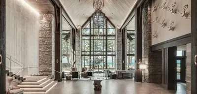 a lobby with a large window and a table at Edgewood Tahoe Resort in Stateline