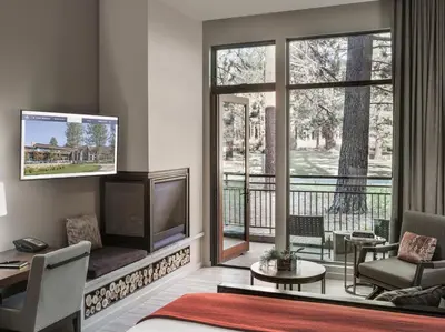 a living room with a television and a balcony at Edgewood Tahoe Resort in Stateline