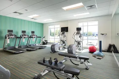 a gym with several treadmills and exercise bikes at Holiday Inn Express Visalia-Sequoia Gateway Area by IHG in Visalia