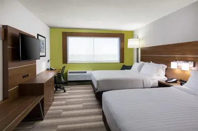 a hotel room with two beds and a flat screen tv at Holiday Inn Express Visalia-Sequoia Gateway Area by IHG in Visalia