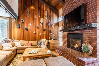 a living room with a couch and a fireplace at Chamonix # 92 in Mammoth Lakes