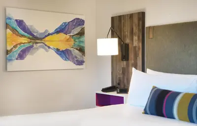 a bedroom with a bed and a painting on the wall at Hotel Becket, BW Signature Collection in South Lake Tahoe