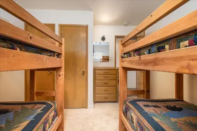 two bunk beds in a room with a bedroom at Evergreen in Wawona